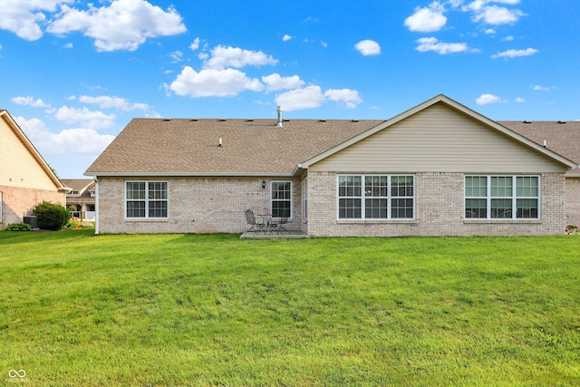 1056 Hilltop Commons Blvd, Whiteland, IN 46184 - back of house featuring brick siding, roof with shingles, and a yard
