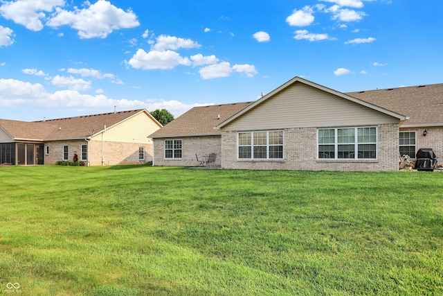 1056 Hilltop Commons Blvd, Whiteland, IN 46184 - back of property featuring brick siding, a lawn, and a shingled roof