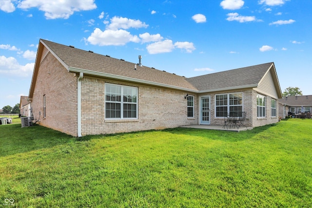 1056 Hilltop Commons Blvd, Whiteland, IN 46184 - rear view of house with brick siding, a patio area, roof with shingles, and a lawn