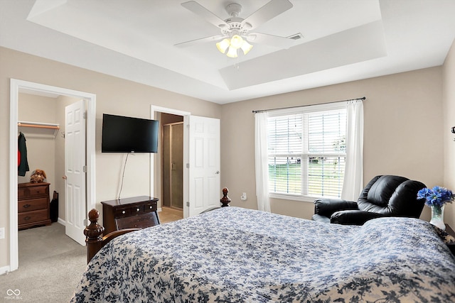 1056 Hilltop Commons Blvd, Whiteland, IN 46184 - bedroom with a tray ceiling, light carpet, a walk in closet, a closet, and a ceiling fan