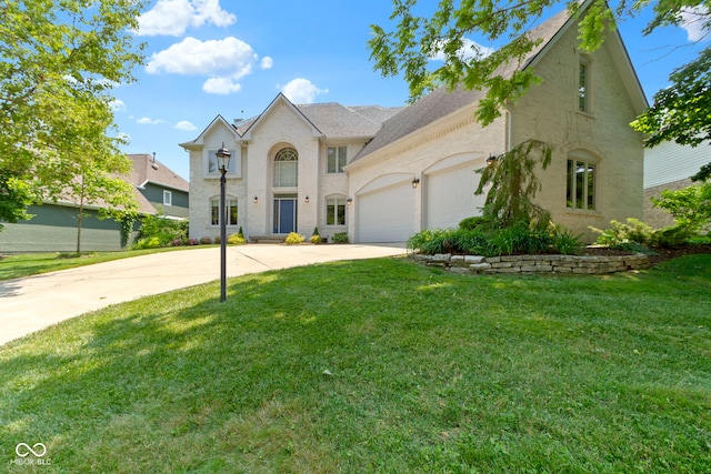 4763 Woods Edge Dr, Zionsville, IN 46077 - french country inspired facade with driveway, a garage, and a front yard