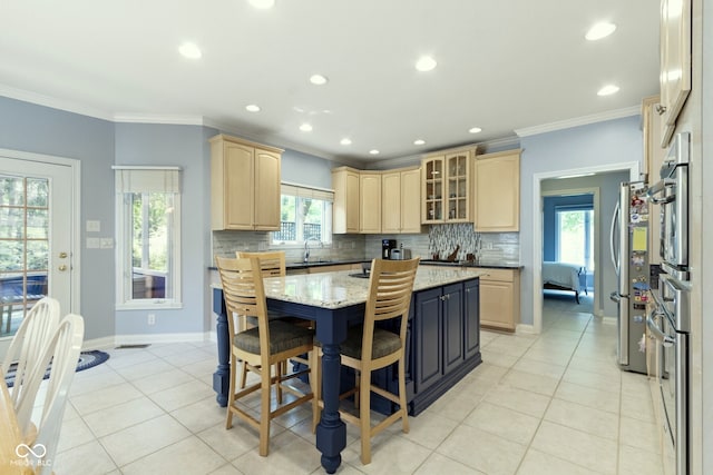 4763 Woods Edge Dr, Zionsville, IN 46077 - kitchen featuring light brown cabinetry, freestanding refrigerator, light tile patterned floors, a center island, and ornamental molding