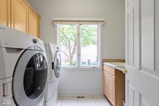 4763 Woods Edge Dr, Zionsville, IN 46077 - laundry room featuring washing machine and dryer, cabinet space, and light tile patterned floors