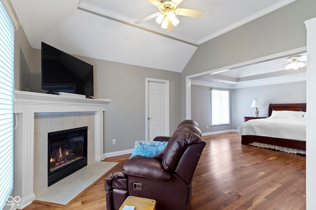 4763 Woods Edge Dr, Zionsville, IN 46077 - bedroom with a tiled fireplace, wood finished floors, vaulted ceiling, crown molding, and ceiling fan