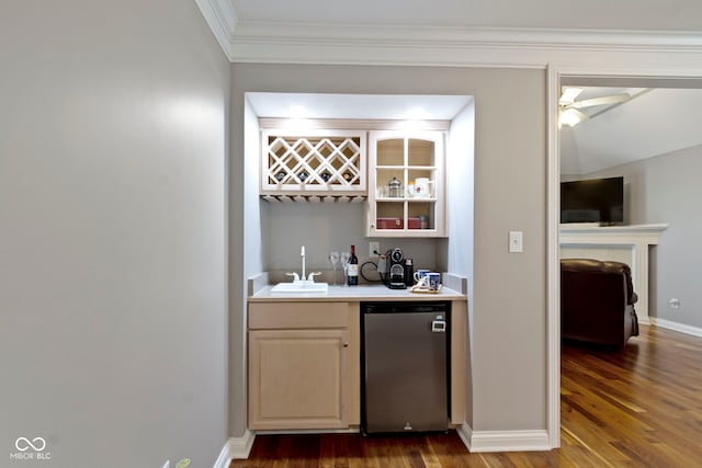 4763 Woods Edge Dr, Zionsville, IN 46077 - indoor wet bar featuring stainless steel dishwasher, wood finished floors, ornamental molding, and a ceiling fan