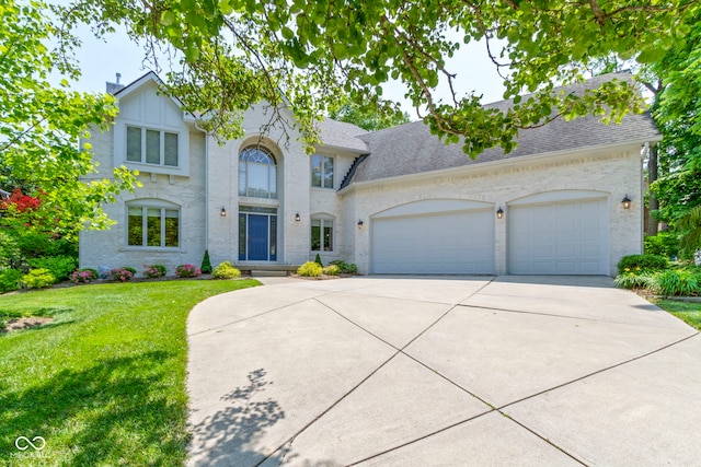 4763 Woods Edge Dr, Zionsville, IN 46077 - view of front facade with an attached garage, driveway, a front yard, and roof with shingles