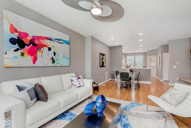 8425 Codesa Way, Indianapolis, IN 46278 - living room featuring light wood-style flooring, a ceiling fan, recessed lighting, and baseboards