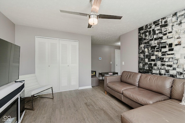8425 Codesa Way, Indianapolis, IN 46278 - living room with wood finished floors, ceiling fan, and a textured ceiling
