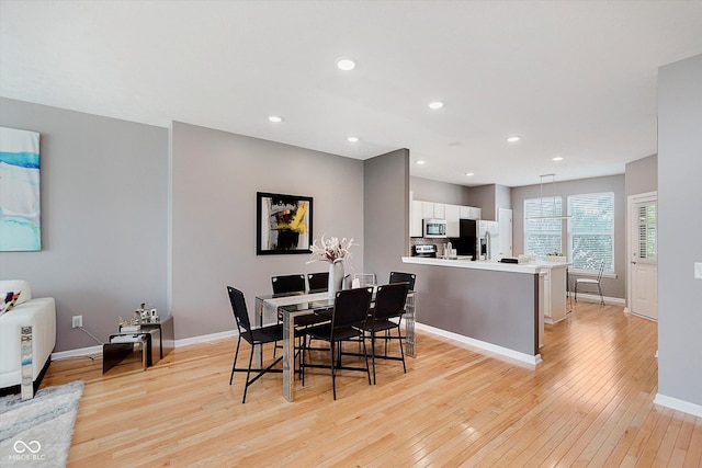 8425 Codesa Way, Indianapolis, IN 46278 - dining area featuring light wood-type flooring, baseboards, and recessed lighting