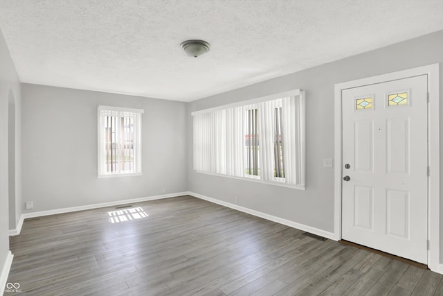 11 14th St, Franklin, IN 46131 - entrance foyer with healthy amount of natural light, wood finished floors, baseboards, and a textured ceiling