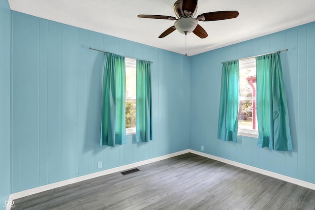 11 14th St, Franklin, IN 46131 - empty room featuring wood finished floors, a ceiling fan, plenty of natural light, and baseboards