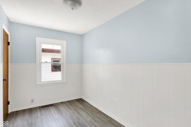 11 14th St, Franklin, IN 46131 - unfurnished room featuring wood finished floors and a wainscoted wall