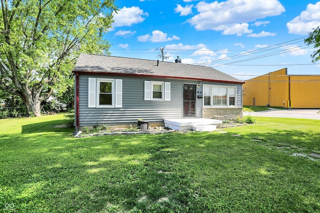 11 14th St, Franklin, IN 46131 - back of property with a lawn and a shingled roof