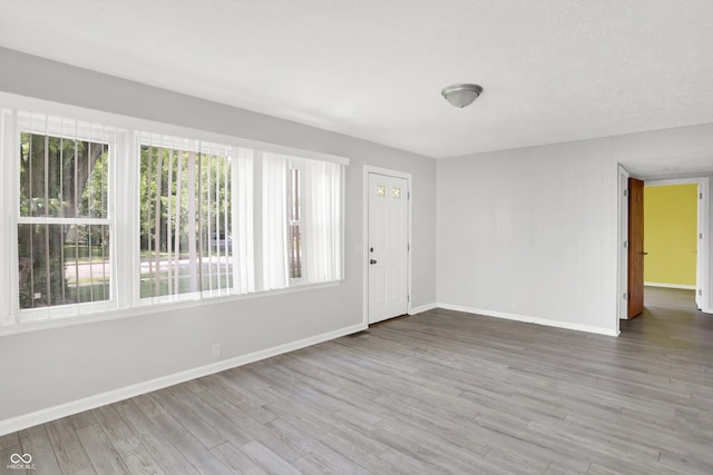 11 14th St, Franklin, IN 46131 - empty room with healthy amount of natural light, baseboards, and wood finished floors
