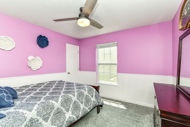 12343 Slate Dr, Fishers, IN 46037 - bedroom with a wainscoted wall, carpet flooring, ceiling fan, and a textured ceiling