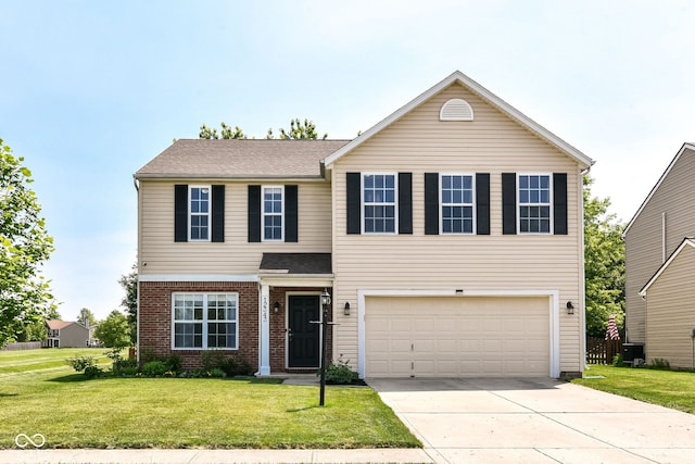 12343 Slate Dr, Fishers, IN 46037 - traditional home featuring an attached garage, concrete driveway, a front yard, brick siding, and central AC
