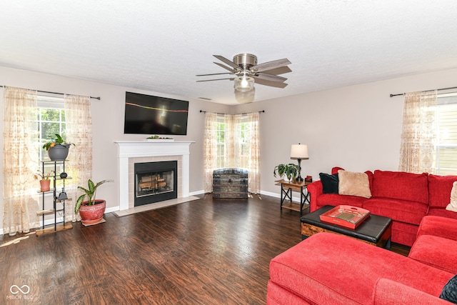 12343 Slate Dr, Fishers, IN 46037 - living room with ceiling fan, a tile fireplace, wood finished floors, baseboards, and a textured ceiling