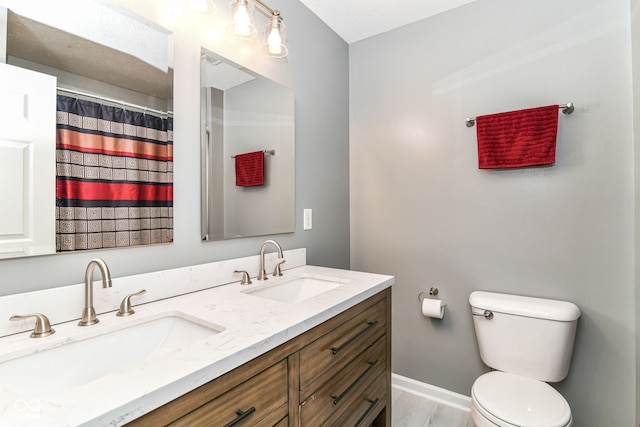 12343 Slate Dr, Fishers, IN 46037 - bathroom featuring double vanity, toilet, and baseboards
