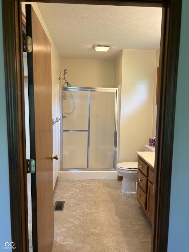 5148 Constitution Ct, Columbus, IN 47203 - full bath featuring toilet, vanity, a stall shower, and a textured ceiling