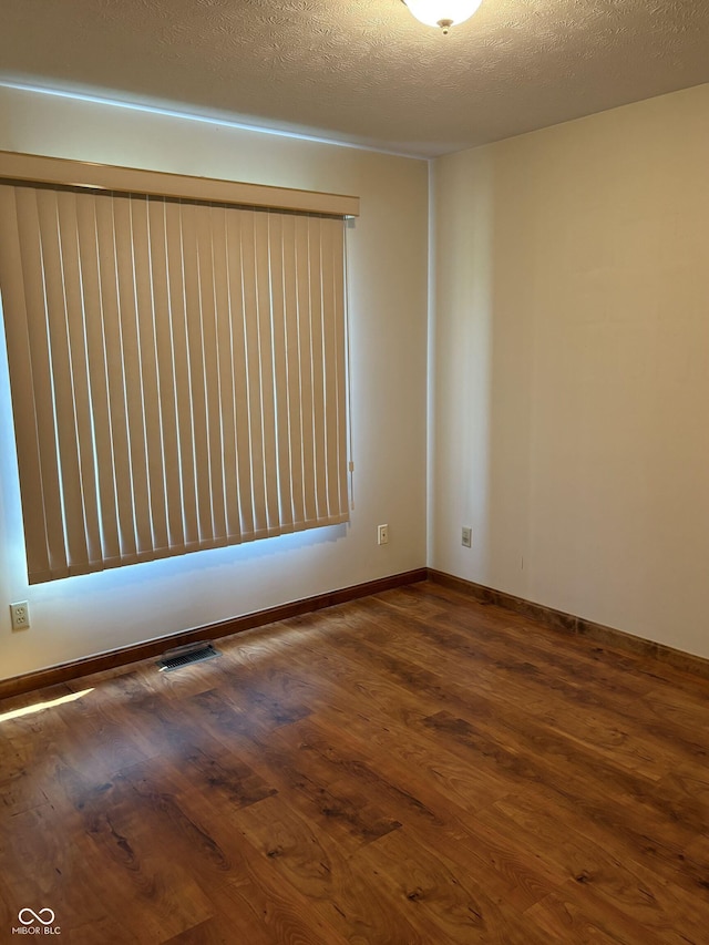 5148 Constitution Ct, Columbus, IN 47203 - unfurnished room with dark wood-style flooring, a textured ceiling, and baseboards