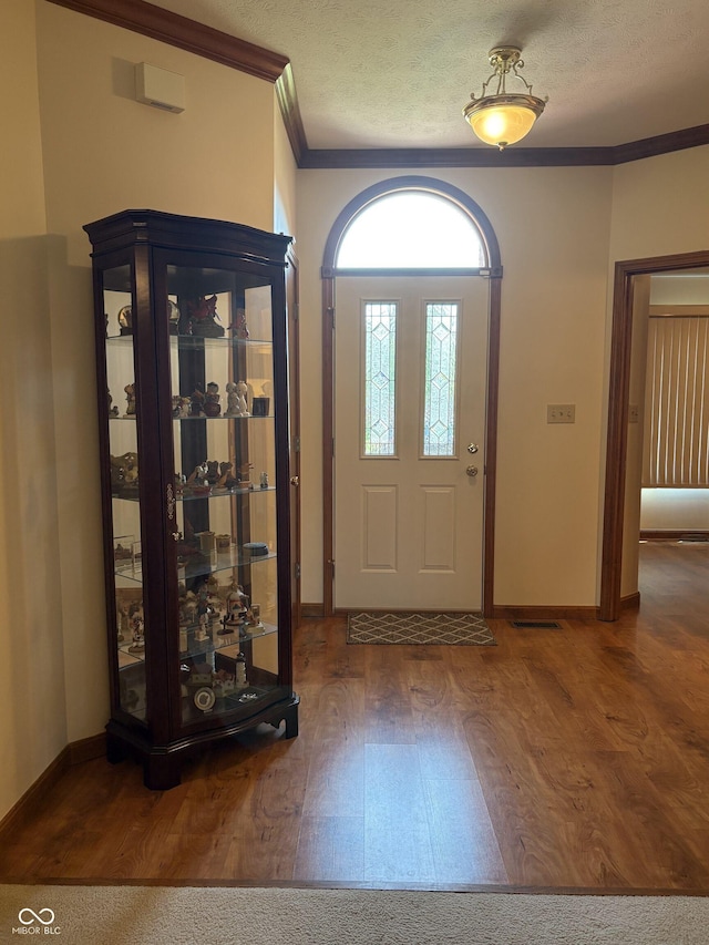 5148 Constitution Ct, Columbus, IN 47203 - entrance foyer featuring wood finished floors, ornamental molding, baseboards, and a textured ceiling