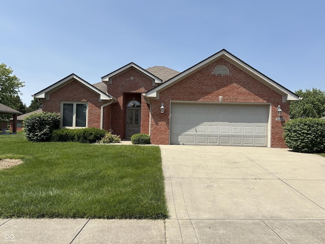 5148 Constitution Ct, Columbus, IN 47203 - ranch-style home with a garage, driveway, a front lawn, and brick siding