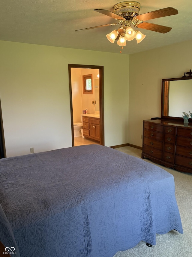 5148 Constitution Ct, Columbus, IN 47203 - bedroom featuring ensuite bathroom, ceiling fan, and light colored carpet