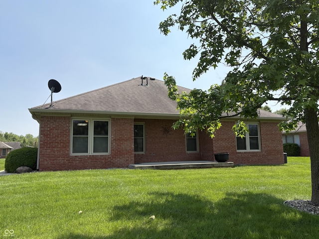 5148 Constitution Ct, Columbus, IN 47203 - back of house featuring brick siding, a yard, and a shingled roof