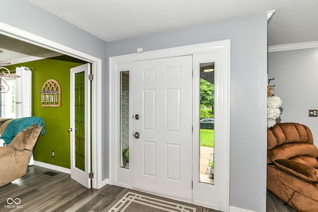164 Wellington Pkwy, Noblesville, IN 46060 - entrance foyer with dark wood-style flooring, baseboards, and crown molding