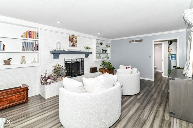 164 Wellington Pkwy, Noblesville, IN 46060 - living room featuring wood finished floors, baseboards, crown molding, a fireplace, and built in features