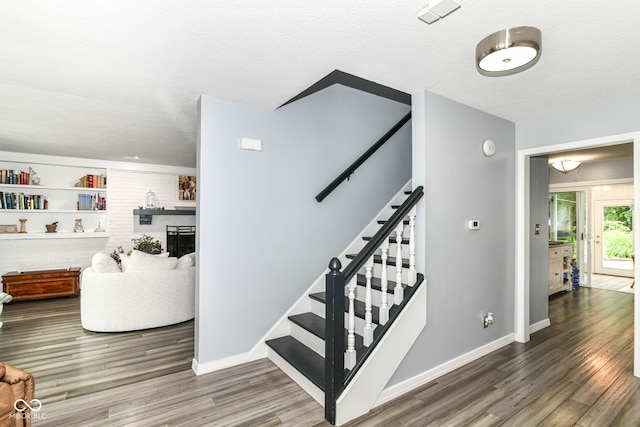 164 Wellington Pkwy, Noblesville, IN 46060 - stairway featuring wood finished floors, baseboards, and a textured ceiling