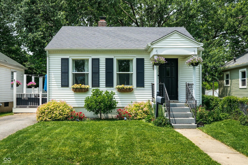 250 N 18th Ave, Beech Grove, IN 46107 - bungalow-style house with a front yard, a chimney, and a shingled roof