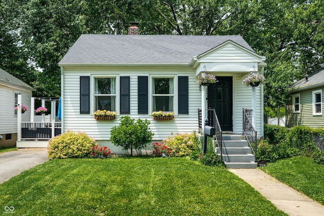 250 N 18th Ave, Beech Grove, IN 46107 - bungalow-style house with a front yard, a chimney, and a shingled roof