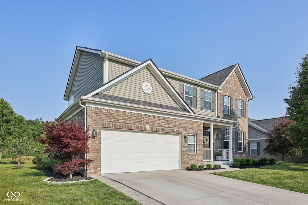 9840 N Anchor Bnd, Mccordsville, IN 46055 - view of front of property featuring concrete driveway, a front yard, brick siding, and a porch