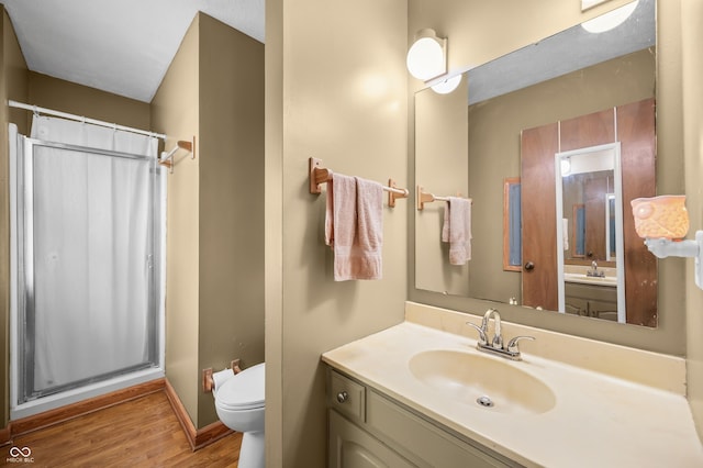 3210 Flintwood Dr, Columbus, IN 47203 - full bath featuring toilet, a shower stall, wood finished floors, vanity, and baseboards
