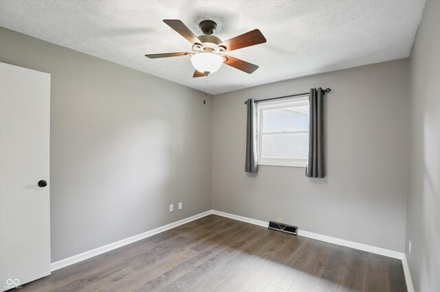 8635 Bishops Ln, Indianapolis, IN 46217 - empty room with baseboards, wood finished floors, a ceiling fan, and a textured ceiling
