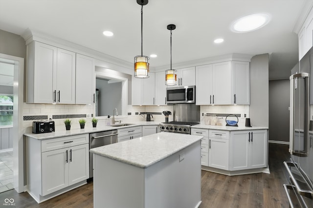 8635 Bishops Ln, Indianapolis, IN 46217 - kitchen featuring appliances with stainless steel finishes, a sink, a center island, white cabinetry, and backsplash