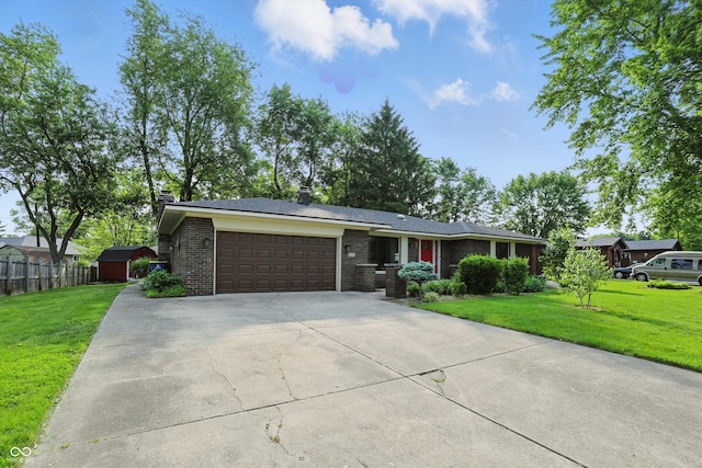 8635 Bishops Ln, Indianapolis, IN 46217 - view of front facade featuring a garage, driveway, a chimney, and brick siding