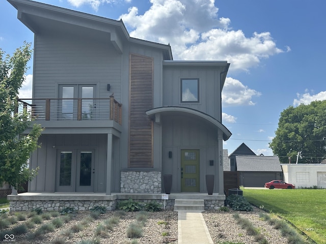 1622 Cornell Ave, Indianapolis, IN 46202 - modern home with board and batten siding, french doors, a balcony, and a front yard