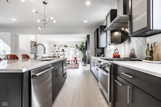 1622 Cornell Ave, Indianapolis, IN 46202 - kitchen with appliances with stainless steel finishes, wall chimney range hood, light countertops, recessed lighting, and an island with sink