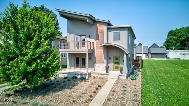 1622 Cornell Ave, Indianapolis, IN 46202 - contemporary house with french doors, board and batten siding, a front lawn, a balcony, and stone siding