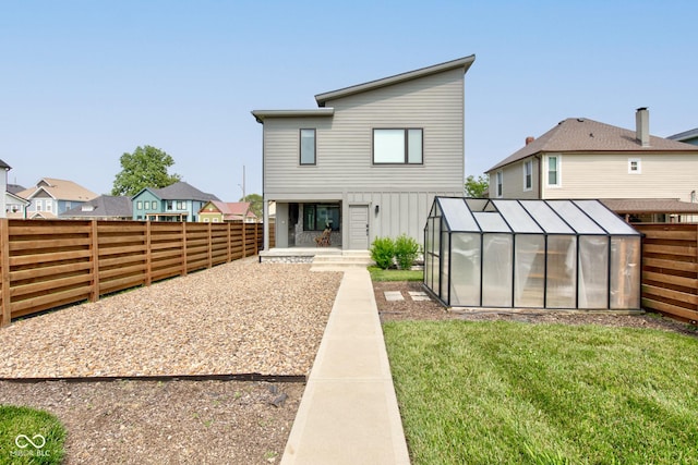 1622 Cornell Ave, Indianapolis, IN 46202 - back of house featuring a greenhouse, a fenced backyard, an outdoor structure, and a residential view