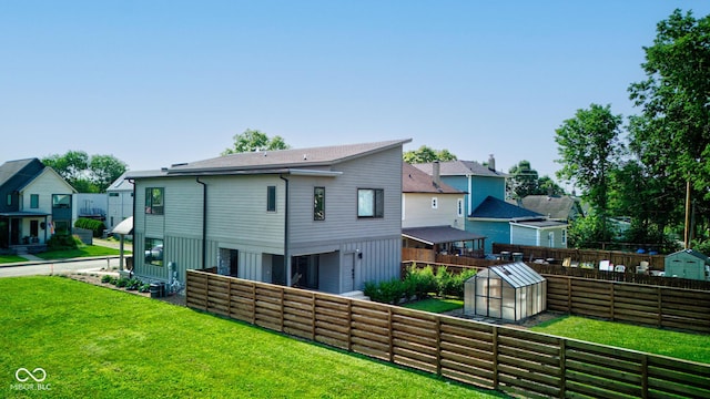 1622 Cornell Ave, Indianapolis, IN 46202 - rear view of house featuring a fenced backyard, an outdoor structure, an exterior structure, and a residential view