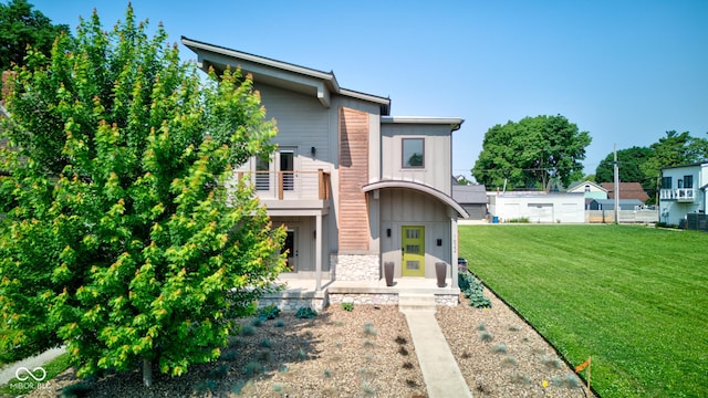 1622 Cornell Ave, Indianapolis, IN 46202 - contemporary home with stone siding, a balcony, and a front lawn