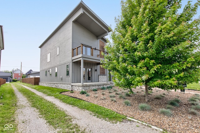 1622 Cornell Ave, Indianapolis, IN 46202 - view of side of home with board and batten siding and a balcony