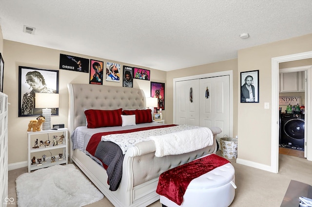 9605 Treyburn Green Way, Indianapolis, IN 46239 - bedroom with washer / dryer, carpet flooring, a closet, and a textured ceiling