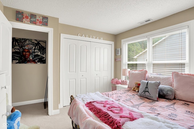 9605 Treyburn Green Way, Indianapolis, IN 46239 - bedroom with light colored carpet, a closet, and a textured ceiling
