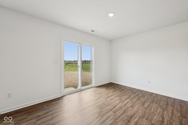 1304 Vera Blvd, Danville, IN 46122 - unfurnished room with wood finished floors, baseboards, and recessed lighting