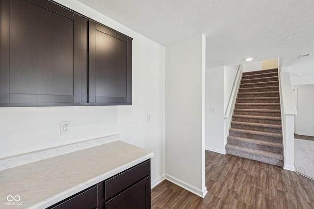 1304 Vera Blvd, Danville, IN 46122 - kitchen with dark wood-style floors, baseboards, light countertops, dark brown cabinets, and a textured ceiling
