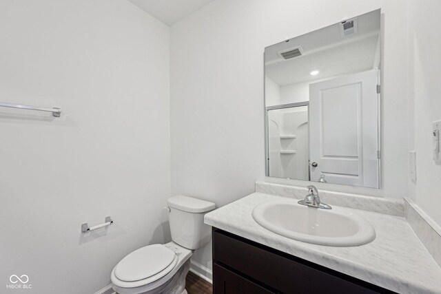 1304 Vera Blvd, Danville, IN 46122 - bathroom featuring toilet, vanity, baseboards, and a shower